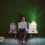 a man working with computer outdoord