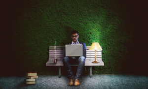 a man working with computer outdoord